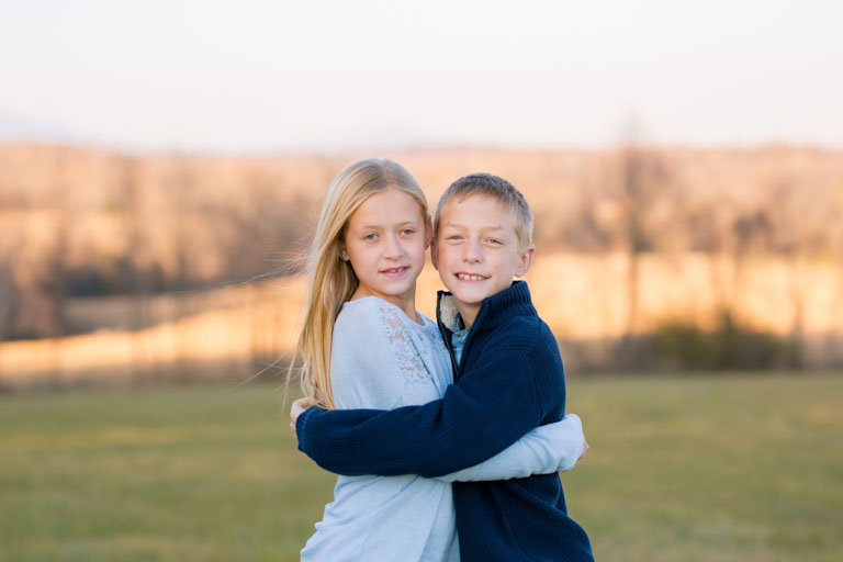 fall family photos in a field with mountains at sweet briar college